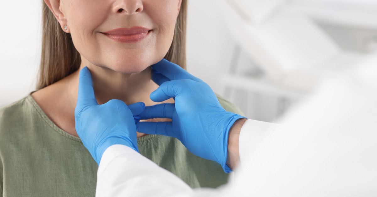 endocrinologist examining thyroid gland of patient indoors closeup
